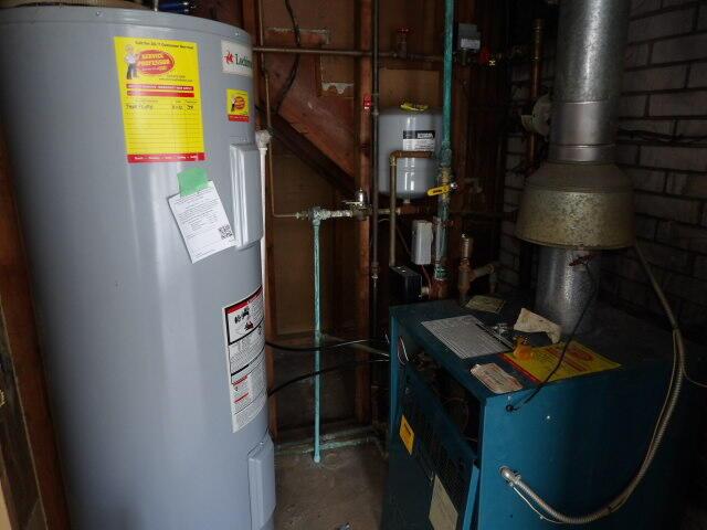 utility room featuring water heater