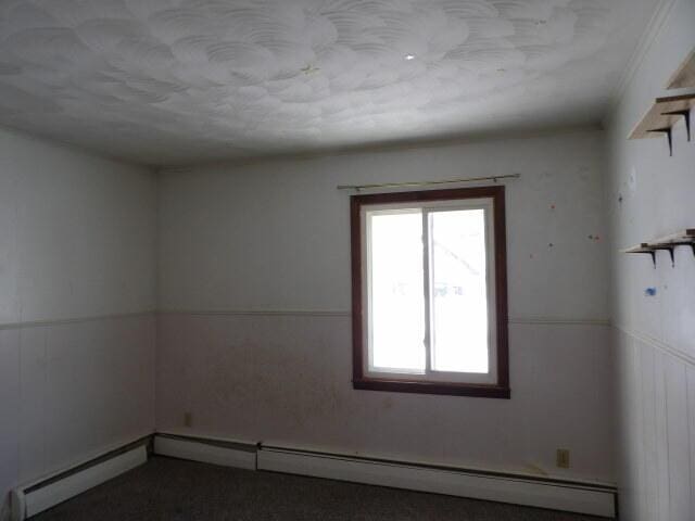 spare room with a baseboard heating unit