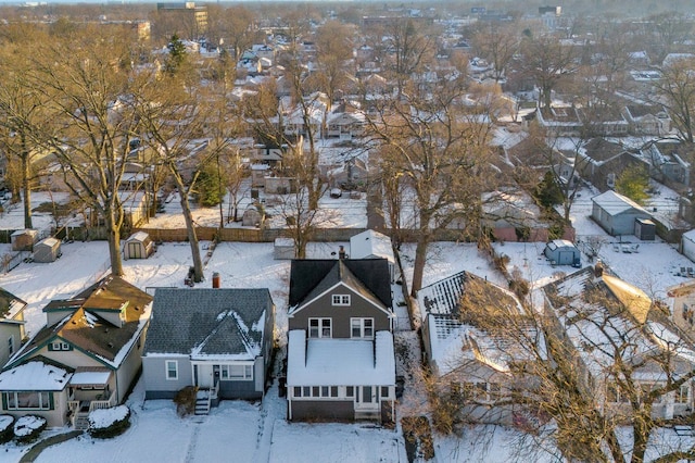 snowy aerial view with a residential view