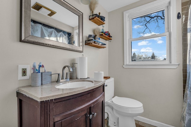 full bath featuring toilet, baseboards, and vanity