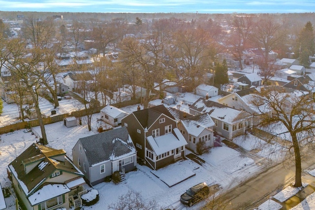 snowy aerial view with a residential view