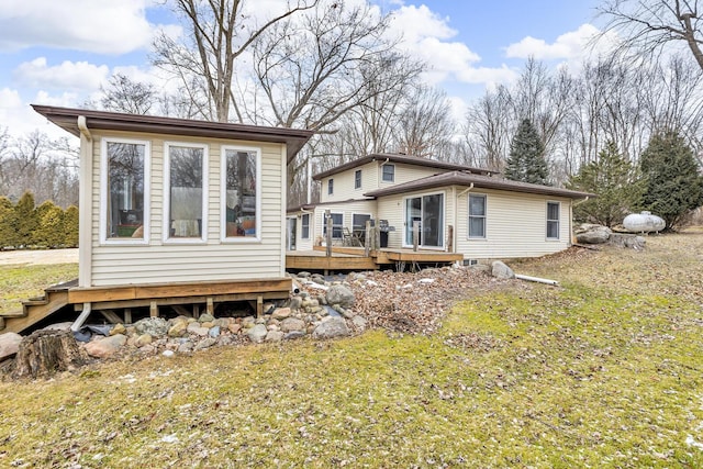 rear view of property featuring a wooden deck