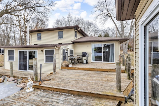 back of property with a wooden deck