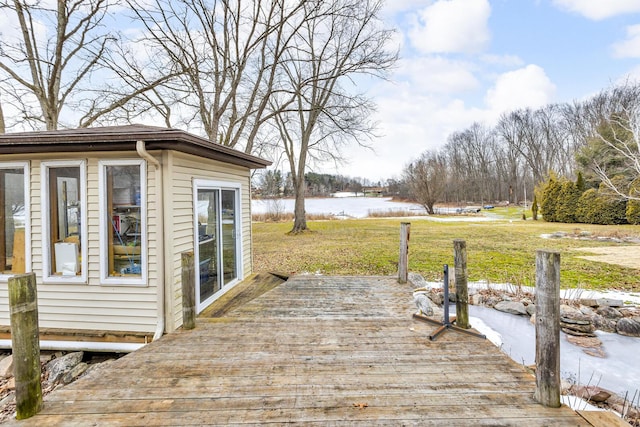 wooden terrace featuring a lawn and a water view