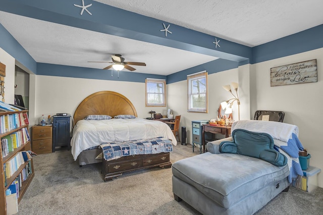 bedroom with carpet floors, ceiling fan, and a textured ceiling