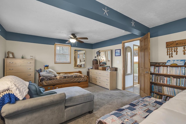 carpeted bedroom with a textured ceiling and a ceiling fan