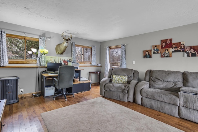 office with hardwood / wood-style flooring and baseboards