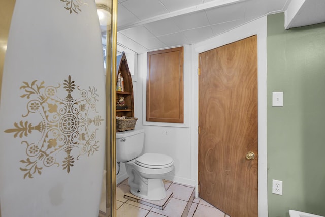 bathroom with toilet and tile patterned floors