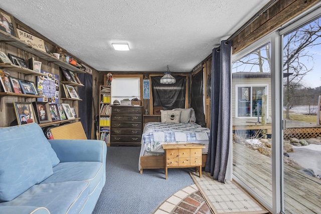 bedroom with a textured ceiling and carpet flooring