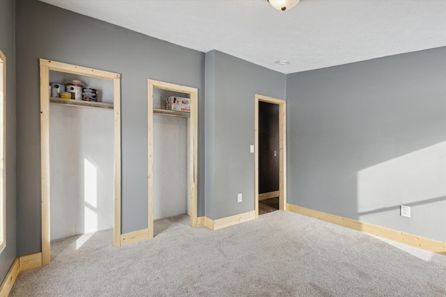 4087 Amble Rd, Coral, MI 49322 - unfurnished bedroom with light carpet and multiple closets