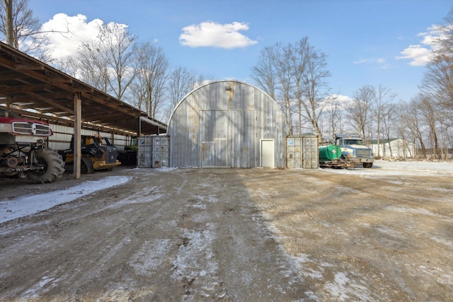 4087 Amble Rd, Coral, MI 49322 - snow covered structure featuring a carport, an outbuilding, and an outdoor structure