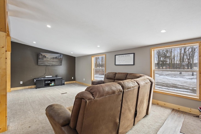 4087 Amble Rd, Coral, MI 49322 - living room featuring baseboards, vaulted ceiling, plenty of natural light, and light colored carpet