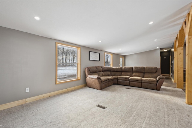 4087 Amble Rd, Coral, MI 49322 - living area with light colored carpet, recessed lighting, visible vents, and plenty of natural light