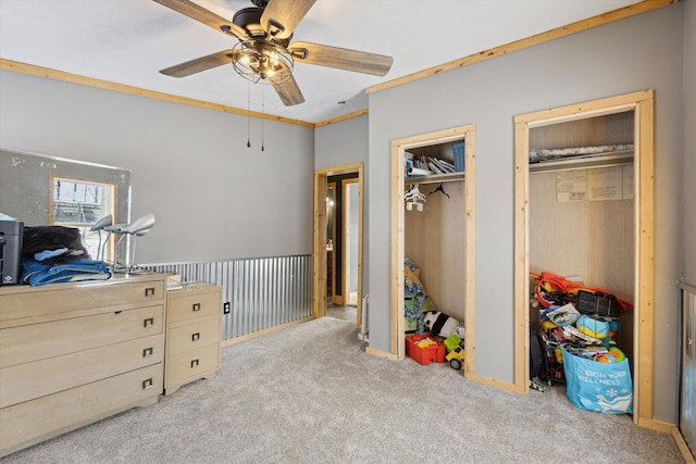 4087 Amble Rd, Coral, MI 49322 - bedroom with light carpet, a ceiling fan, baseboards, multiple closets, and crown molding