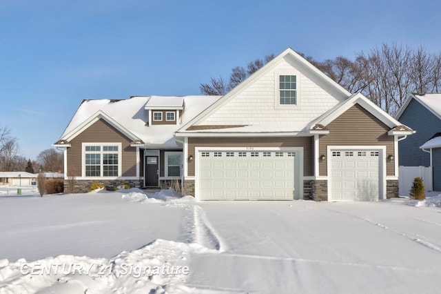 craftsman inspired home featuring a garage and stone siding