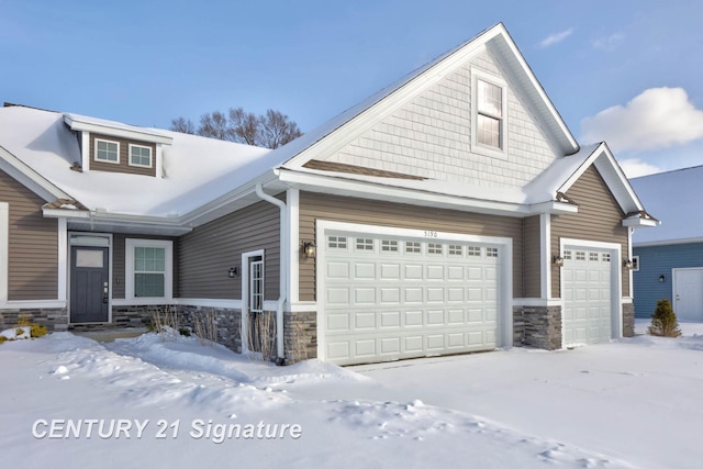 view of front facade featuring stone siding and an attached garage