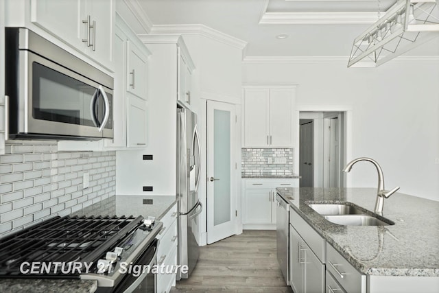 kitchen with appliances with stainless steel finishes, a sink, and white cabinets