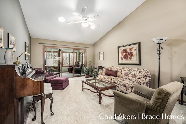 living area with light carpet, ceiling fan, and high vaulted ceiling