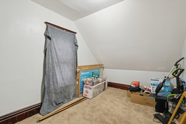 game room featuring light colored carpet and vaulted ceiling