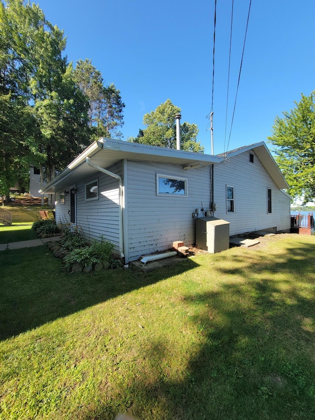 rear view of property featuring a yard