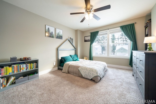 bedroom featuring light carpet, ceiling fan, and baseboards