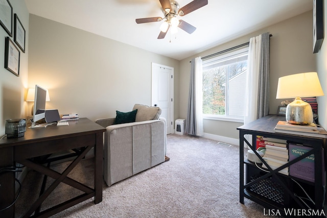 office area featuring light carpet, ceiling fan, and baseboards