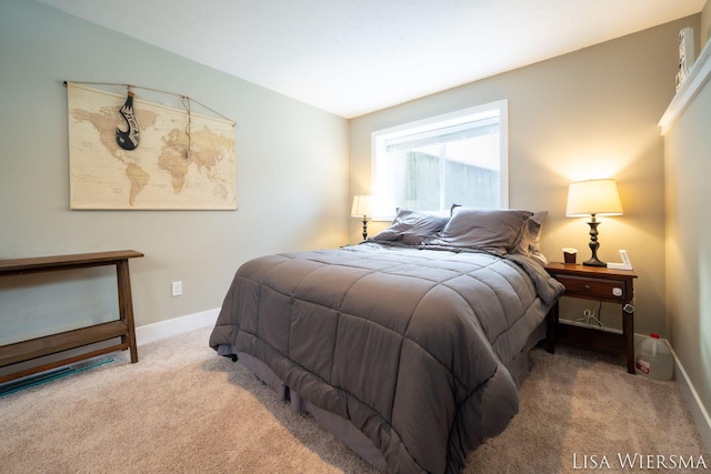 carpeted bedroom featuring baseboards