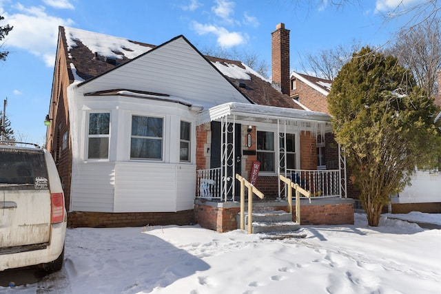 bungalow-style house with covered porch and a chimney