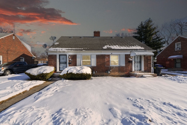 bungalow-style house with brick siding