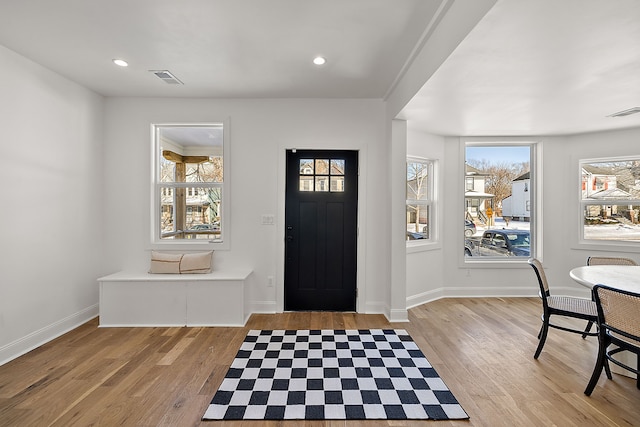 foyer with recessed lighting, baseboards, and wood finished floors