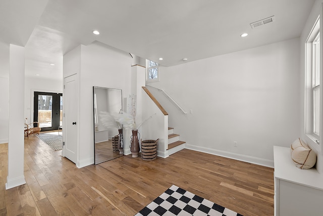 interior space with hardwood / wood-style flooring, visible vents, stairway, and recessed lighting