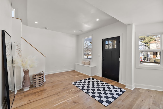 foyer featuring light wood-type flooring, a wealth of natural light, and recessed lighting