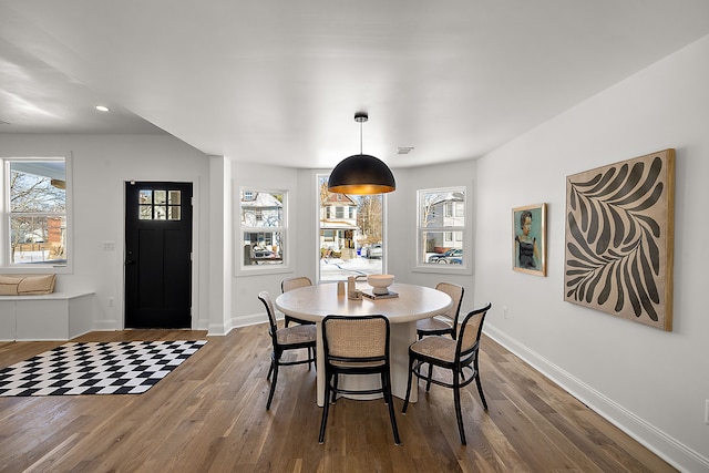 dining area featuring a healthy amount of sunlight, baseboards, and wood finished floors