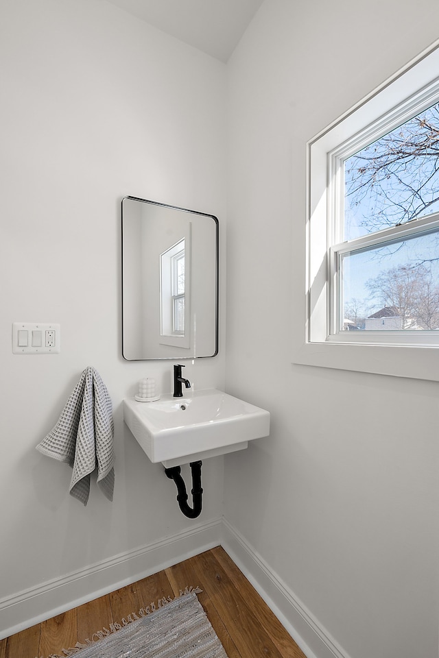 bathroom with baseboards and wood finished floors