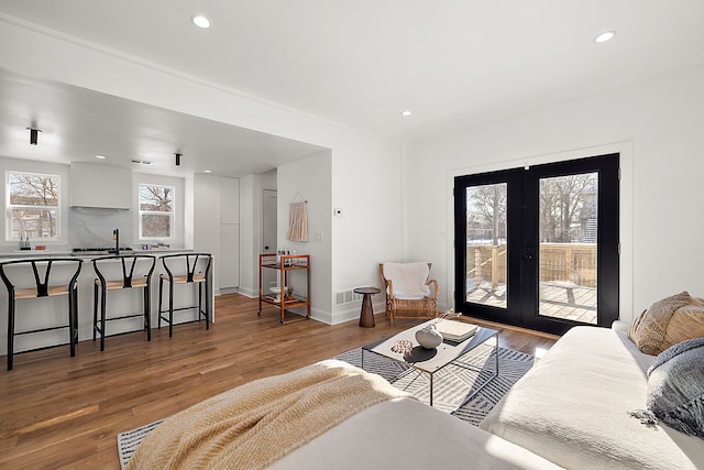 living area featuring french doors, wood finished floors, and recessed lighting