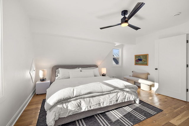 bedroom featuring hardwood / wood-style flooring, baseboards, and a ceiling fan