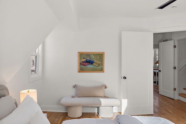 interior space featuring vaulted ceiling with beams, baseboards, and wood finished floors