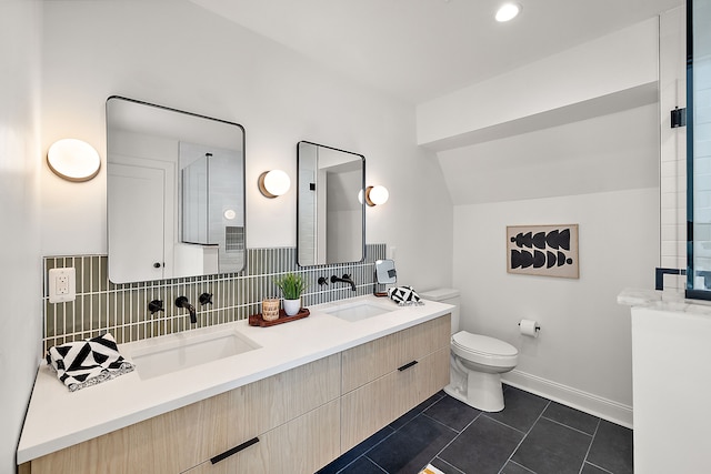 full bathroom featuring double vanity, tasteful backsplash, toilet, a sink, and tile patterned flooring