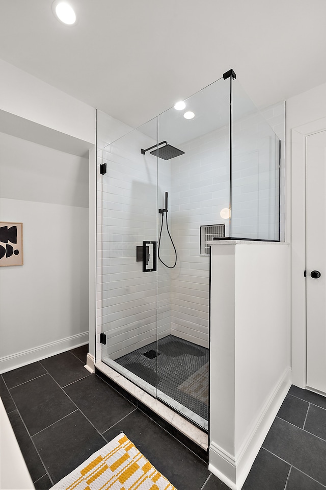 bathroom featuring tile patterned flooring, a shower stall, baseboards, and recessed lighting