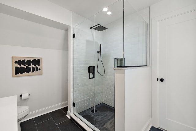 full bathroom with baseboards, a shower stall, toilet, and tile patterned floors