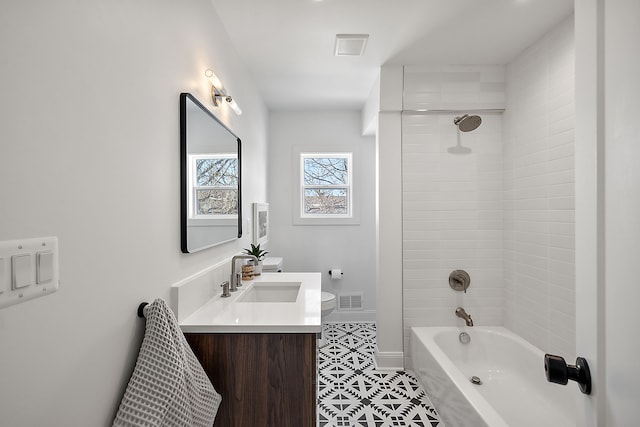 bathroom featuring visible vents, toilet, vanity, and baseboards