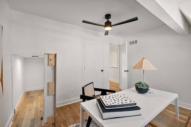 office with visible vents, ceiling fan, light wood-style flooring, and baseboards