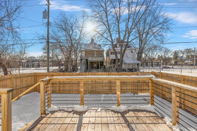 wooden terrace with a fenced backyard