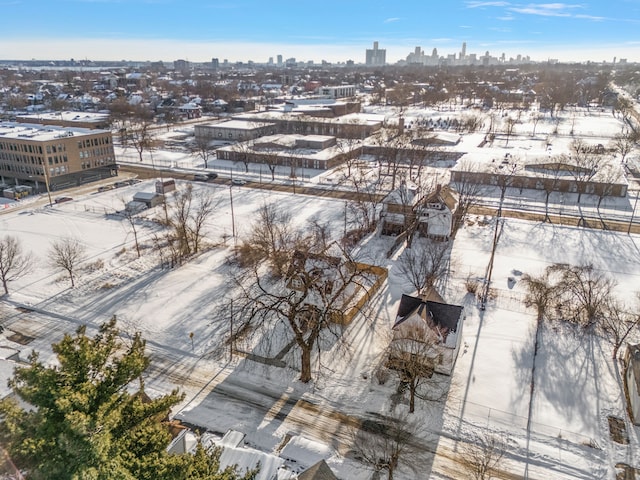 snowy aerial view with a city view