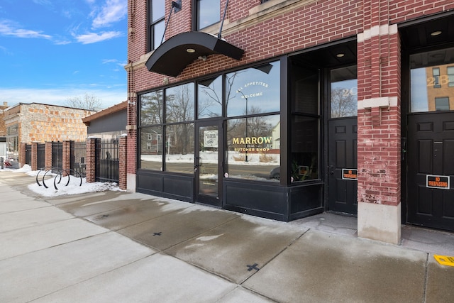 view of exterior entry with brick siding