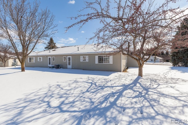 view of snow covered rear of property