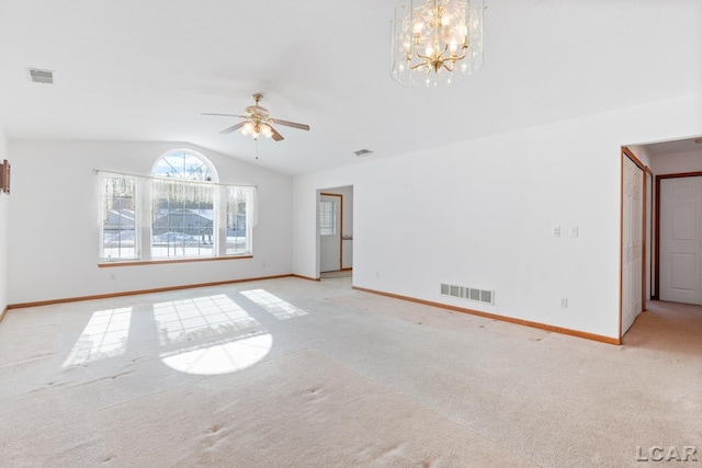 unfurnished room with visible vents, vaulted ceiling, and light colored carpet