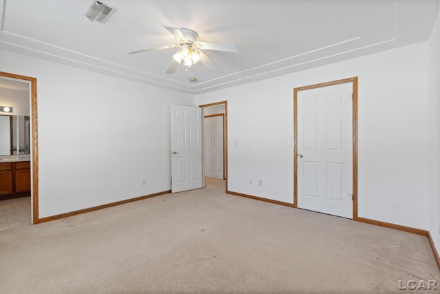 unfurnished bedroom featuring visible vents, ensuite bath, light carpet, and baseboards