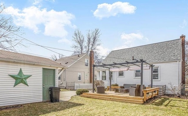 rear view of property with fence, a lawn, a wooden deck, a pergola, and a chimney