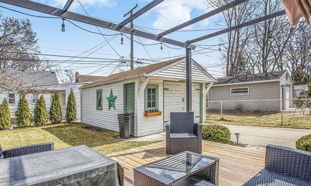 wooden deck with a yard, an outbuilding, and fence